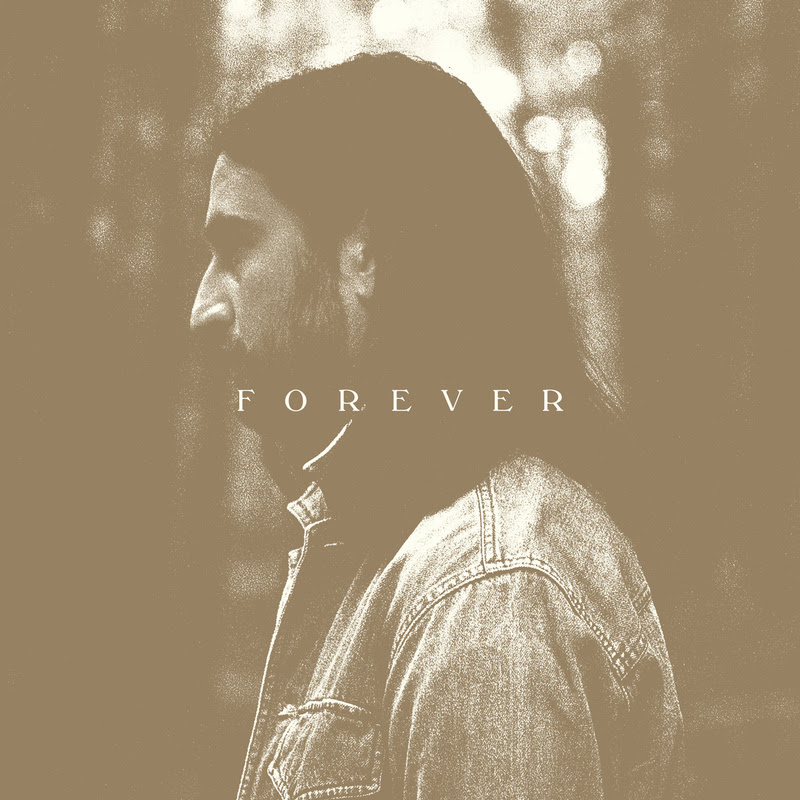 Noah Kahan album cover with Noah facing to the left wearing a denim jacket with the word forever over the top. 