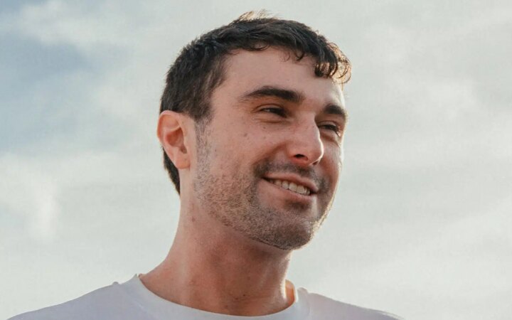 Image shows photo of Fred Again in white t-shirt