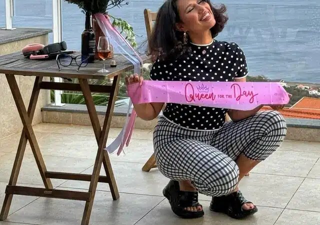 Raye holds a birthday banner after her car was stolen.