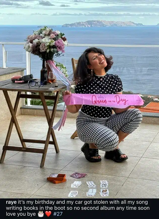 Raye holds a birthday banner after her car was stolen.