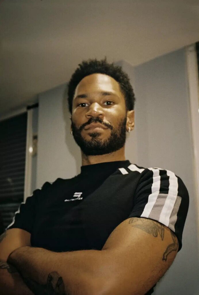 Kaytranada poses for a press shot backstage