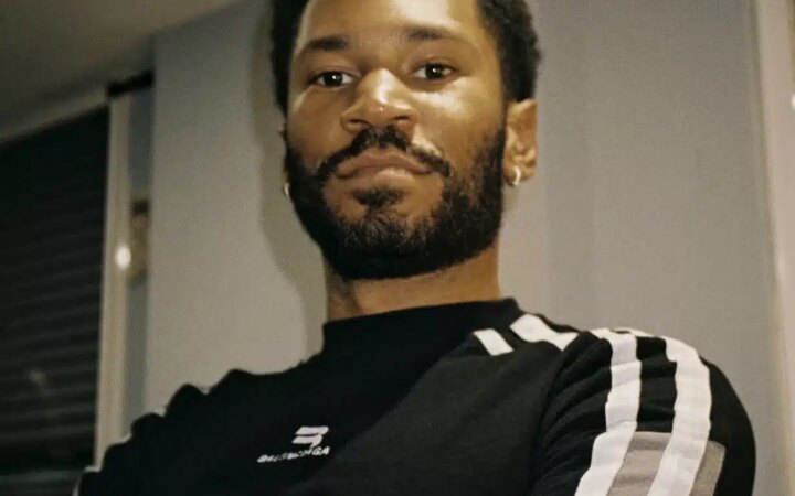 Kaytranada poses for a press shot backstage
