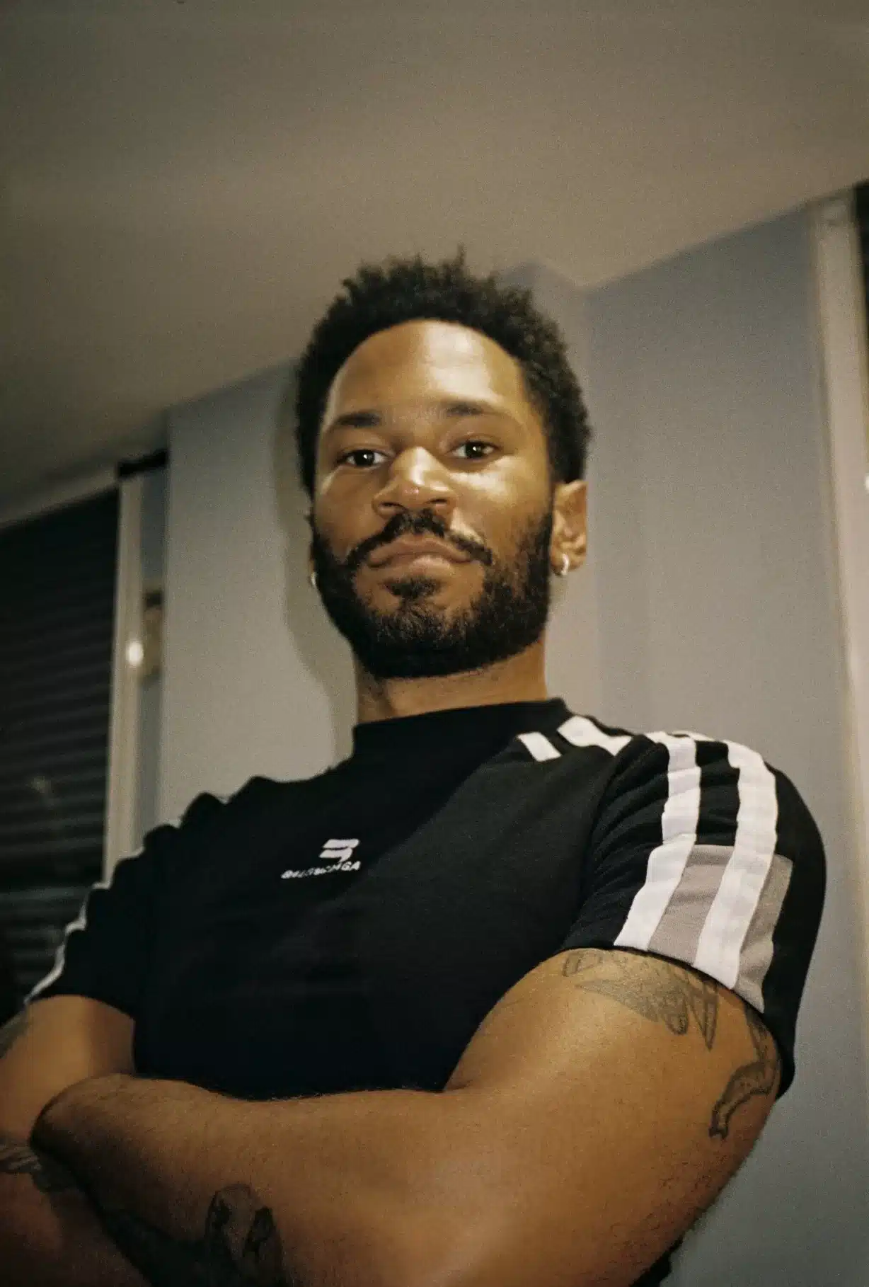 Kaytranada poses for a press shot backstage