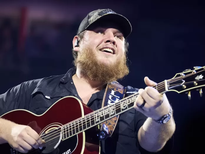 Luke Combs on stage with guitar