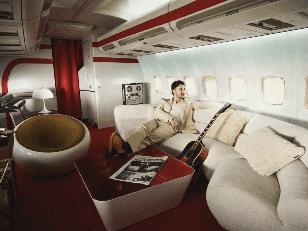 Cian Ducrot sits on the sofa of a private jet