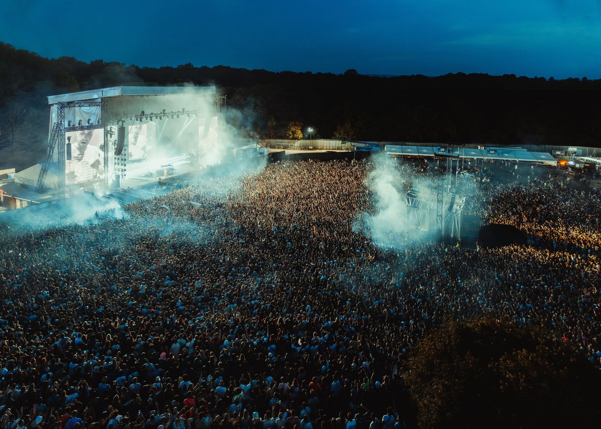 Birdseye view of Parklife Festival in Heaton Park, Manchester. The crowd is large and their is smoke