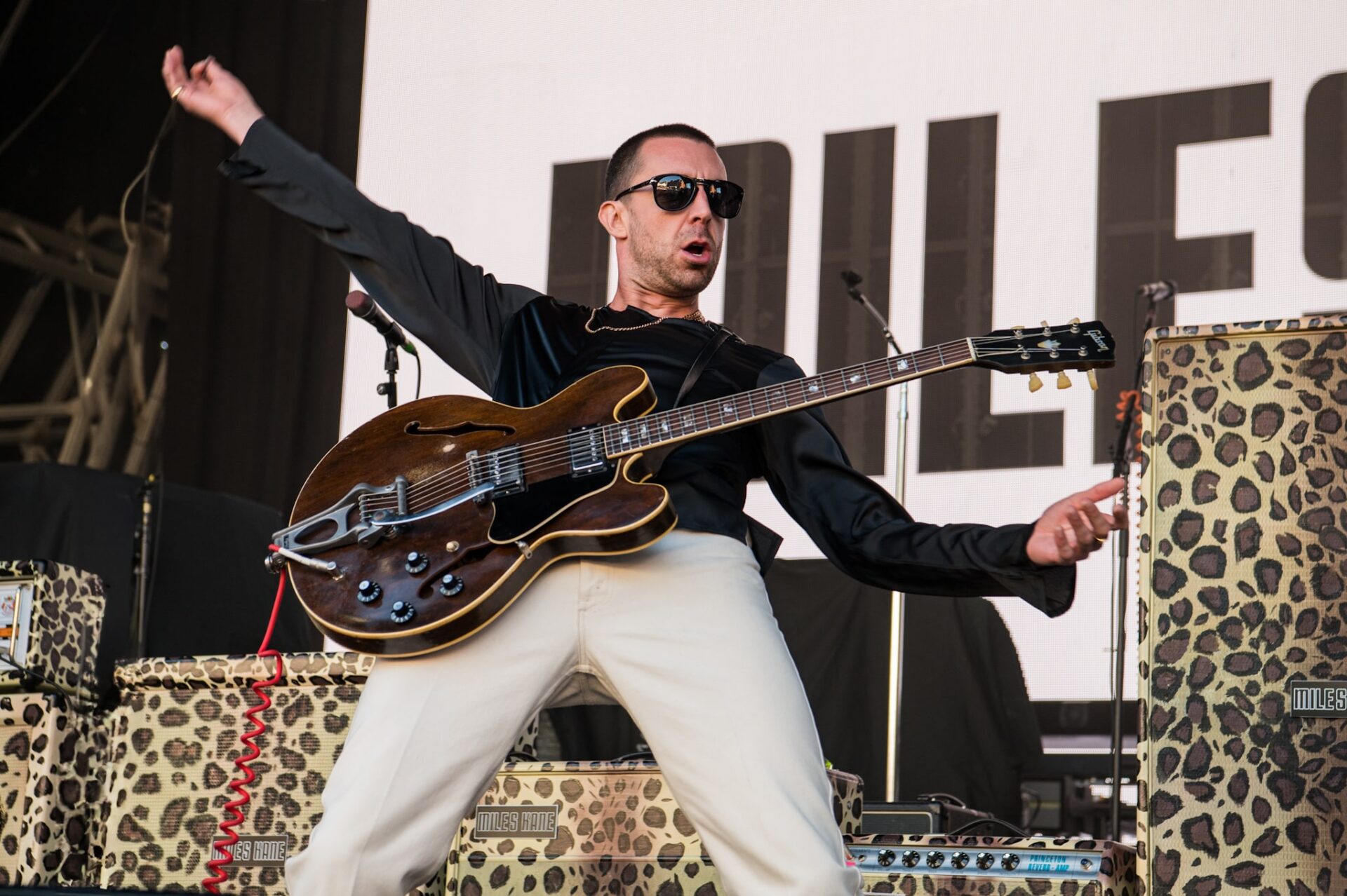 Miles Kane on stage at Castlefield bowl with leopard print instruments