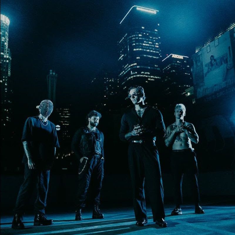 The Dark.FM band stood in a dark city setting