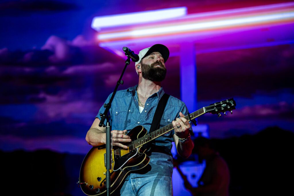 Jordan Davis on stage in Auckland, New Zealand playing guitar.
