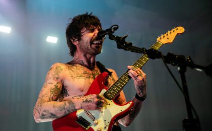 Simon Neil from Biffy Clark on stage in Auckland with a red guitar