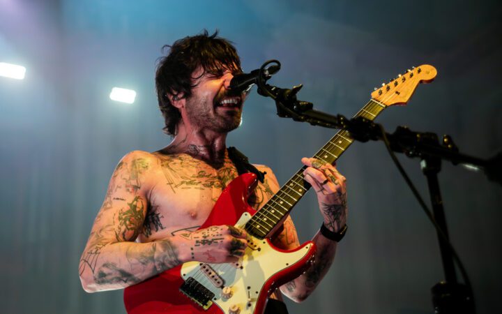 Simon Neil from Biffy Clark on stage in Auckland with a red guitar